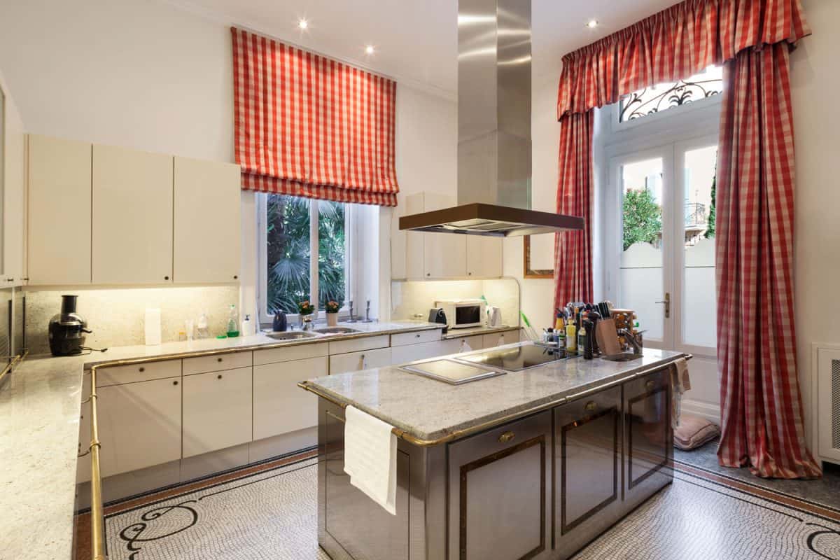 Classic inspired kitchen area with striped red curtains and a marble countertop