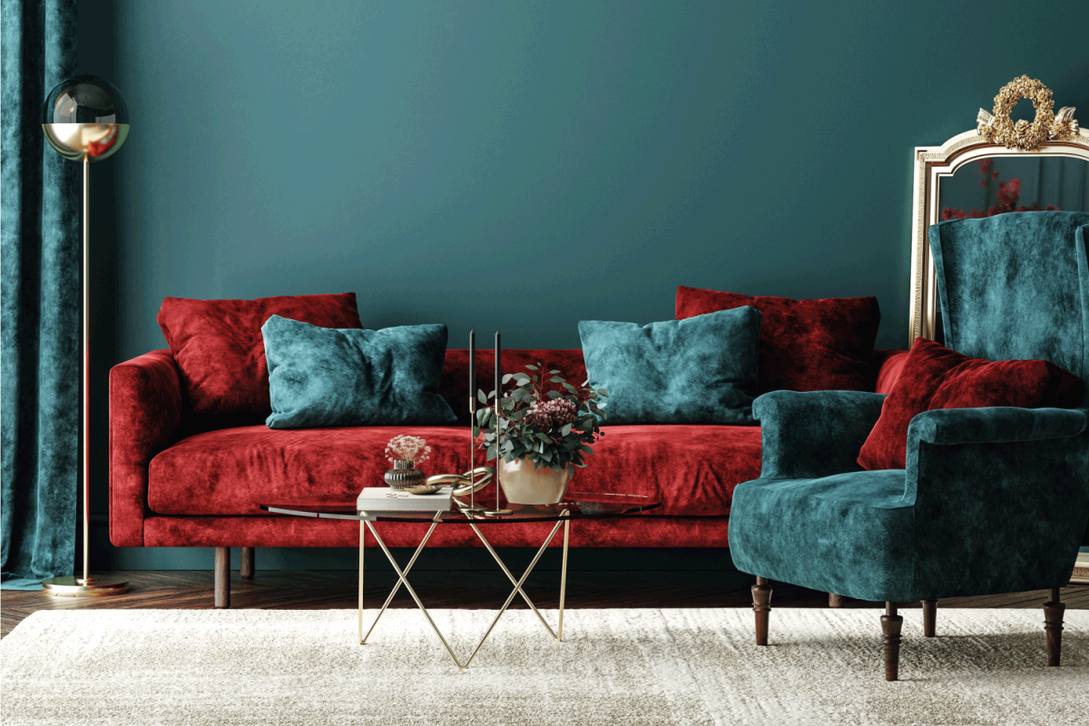Home interior with red sofa, table and decor in green living room
