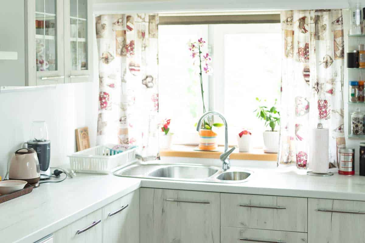 Interior of modern white wooden kitchen, 11 Kitchen Curtain Ideas For Above The Sink