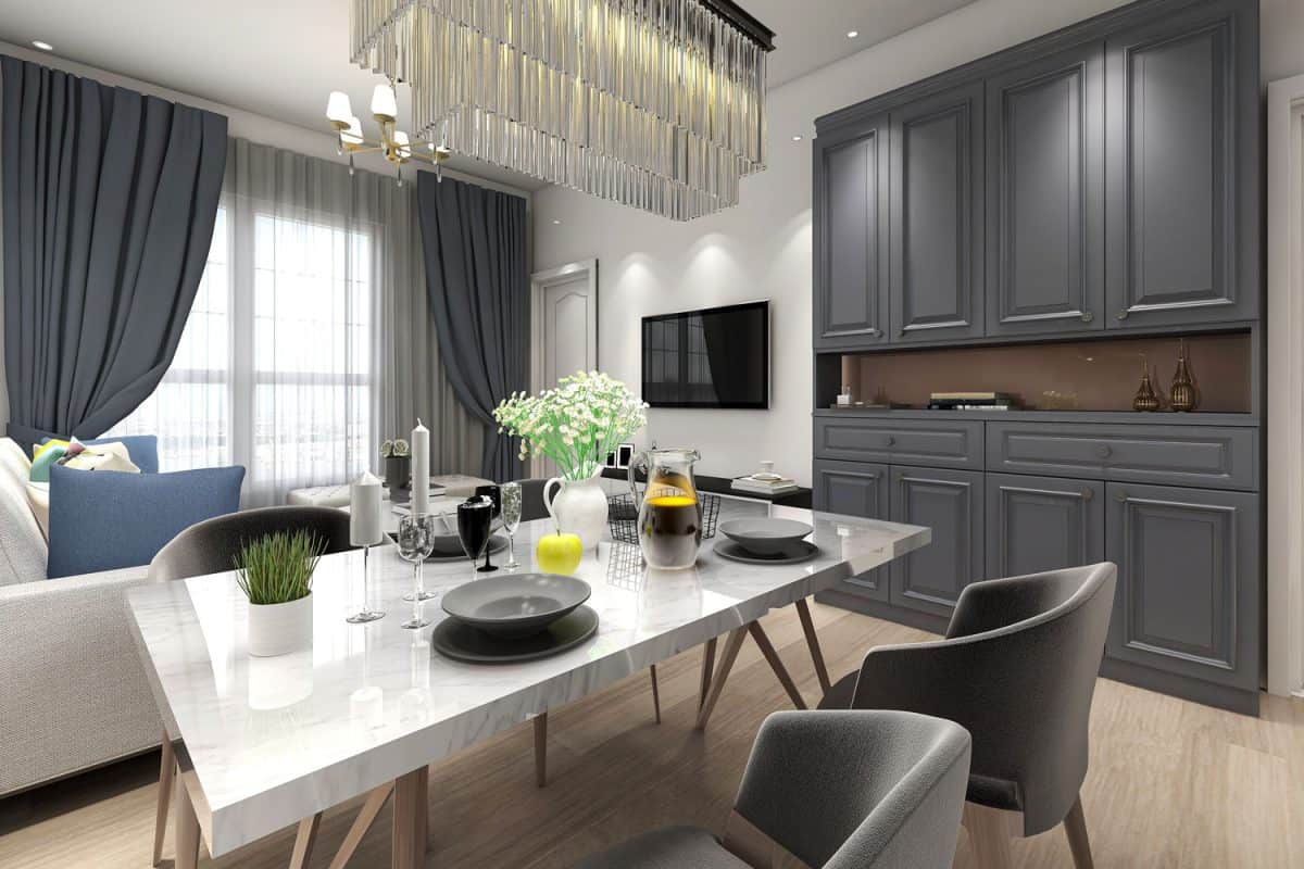 Luxurious modern open space apartment area with black painted cabinets, gray dining chairs and black curtains