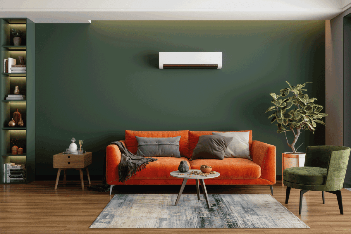 Modern Living Room Interior With Air Conditioner, Orange Sofa And pulpy Green Armchair