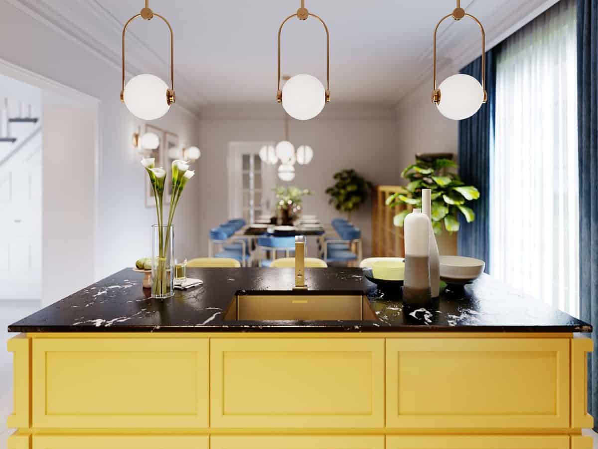 Modern kitchen island in yellow kitchen with pendant lamp over
