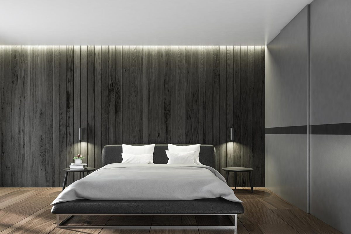 Scandinavian style bedroom with dark wooden walls and a master bed with bedside tables