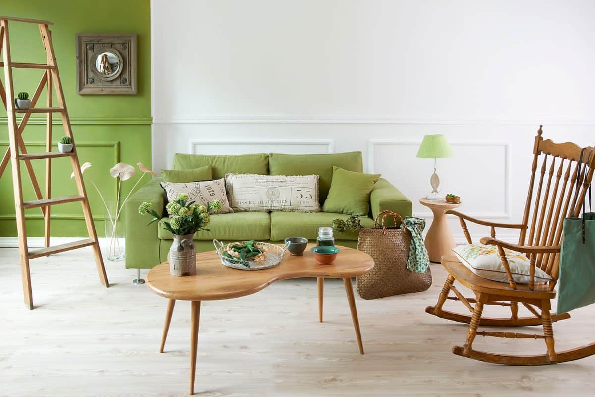 Two colored combination living room with wooden furnitures and a green sofa