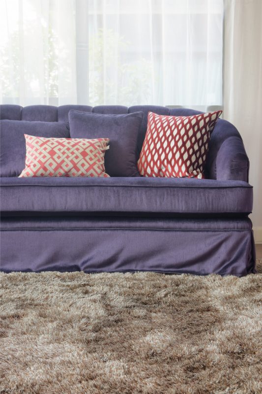 Violet sofa set on brown color carpet in living room