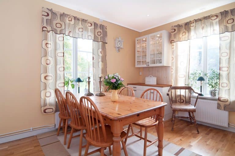 modern interior of a kitchen with a bunch of flowers on top of the table, What Are The Best Fabrics For Kitchen Curtains?