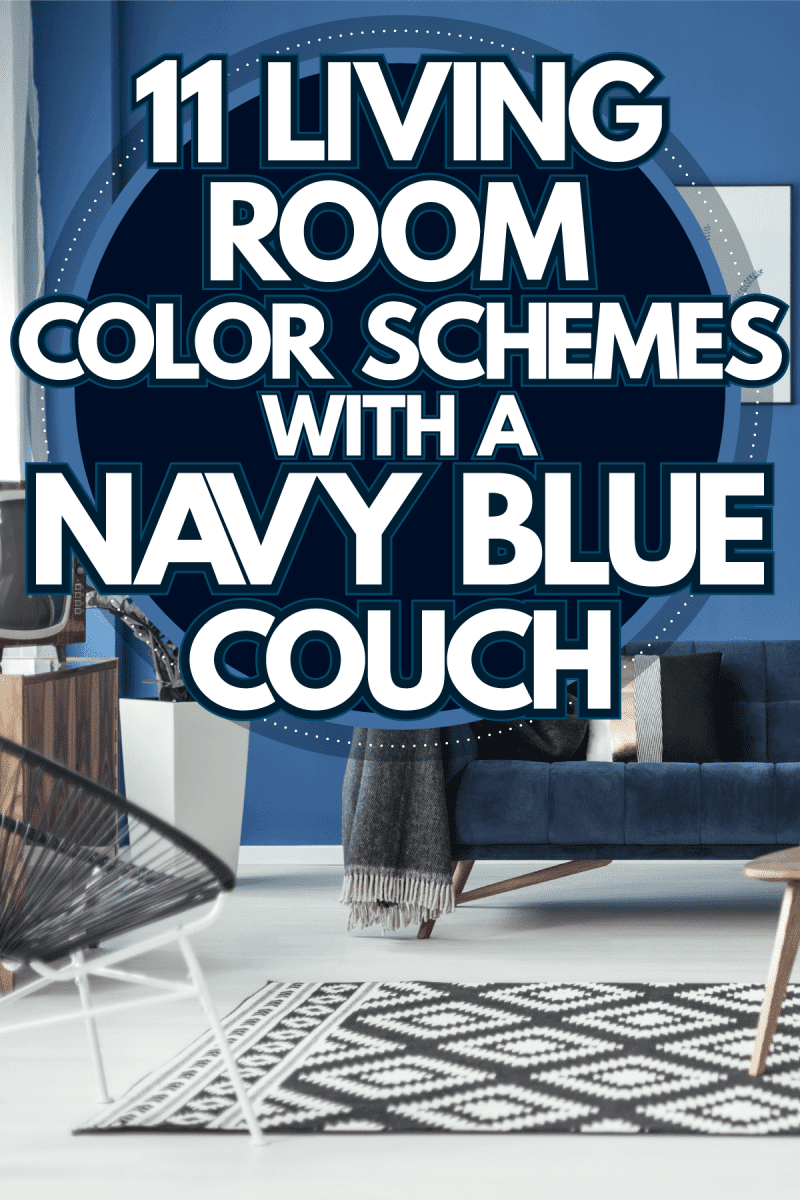 A blue couch with a gray throw, white throw pillows and blue walls decorated with paintings, 11 Living Room Color Schemes With A Navy Blue Couch