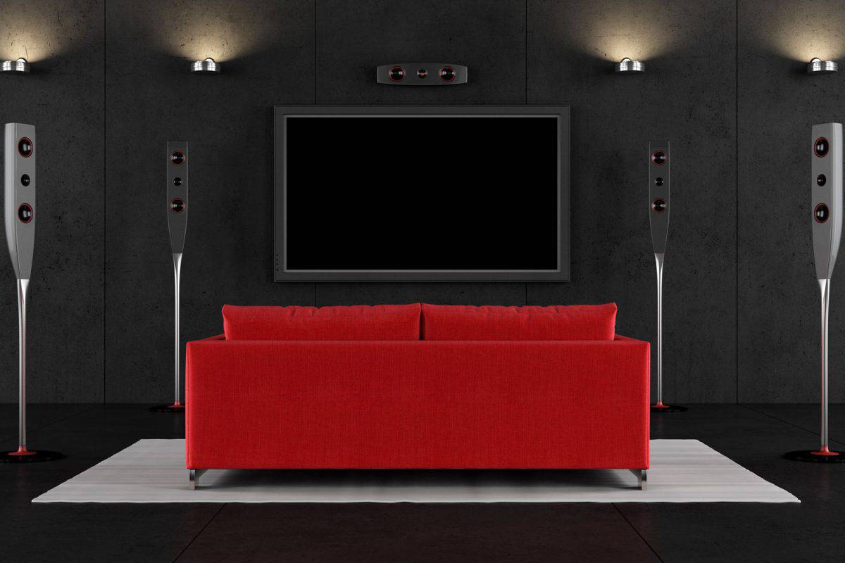 A 4D theater room with red throw pillows and red sofa