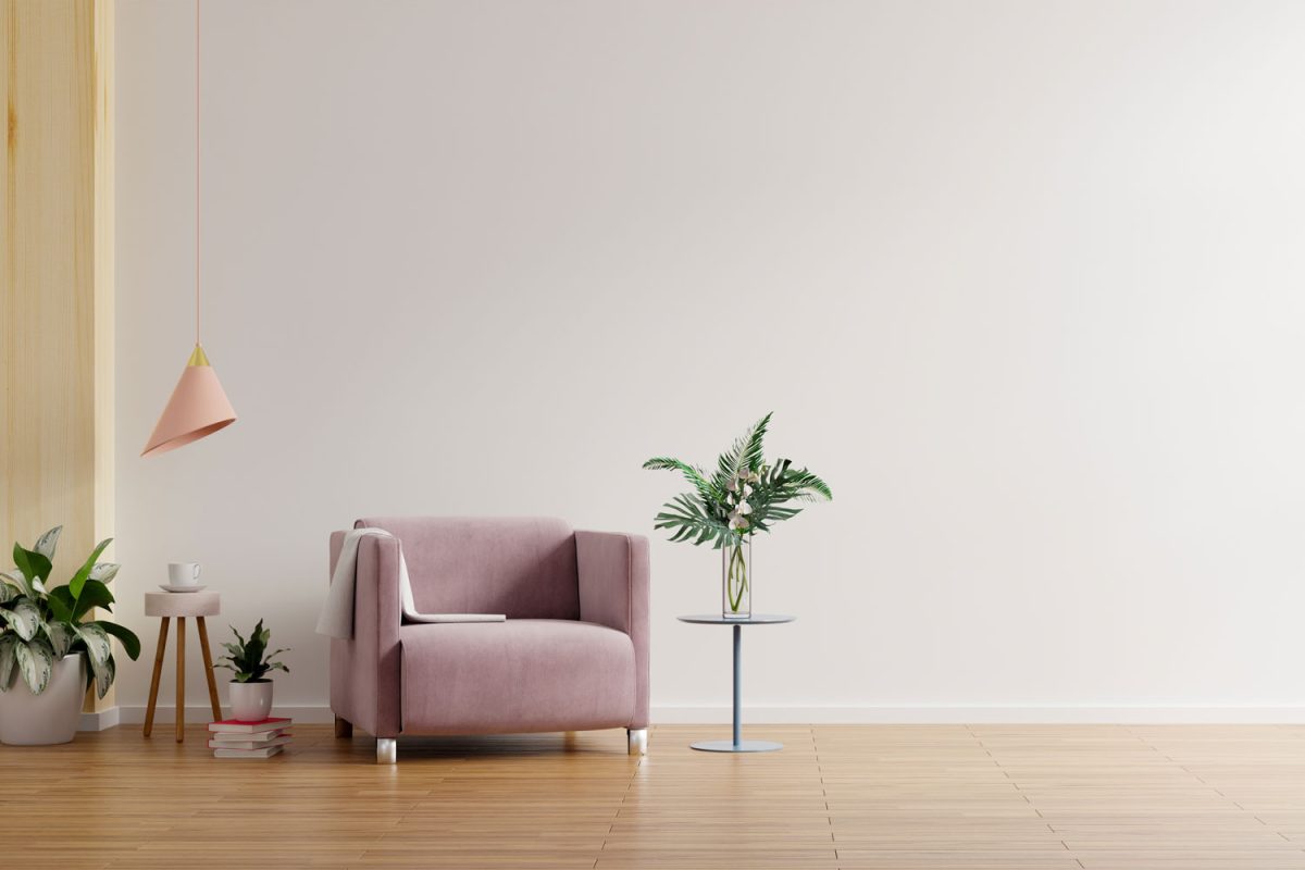 A bright nature like living room with wooden flooring, pink armchair and plants