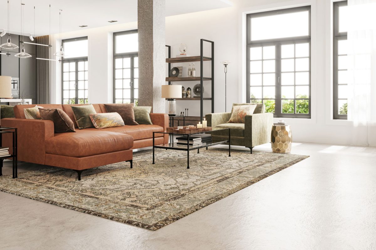 A huge rug and leather sofa inside an industrial inspired living room