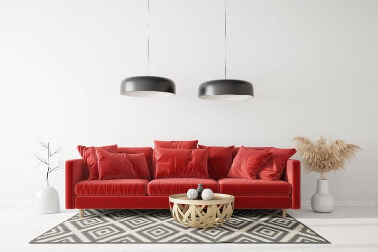 A red colored sofa with a wicker coffee table and dangling lamps, 10 Fabulous Wall Colors For Living Room With Red Sofa