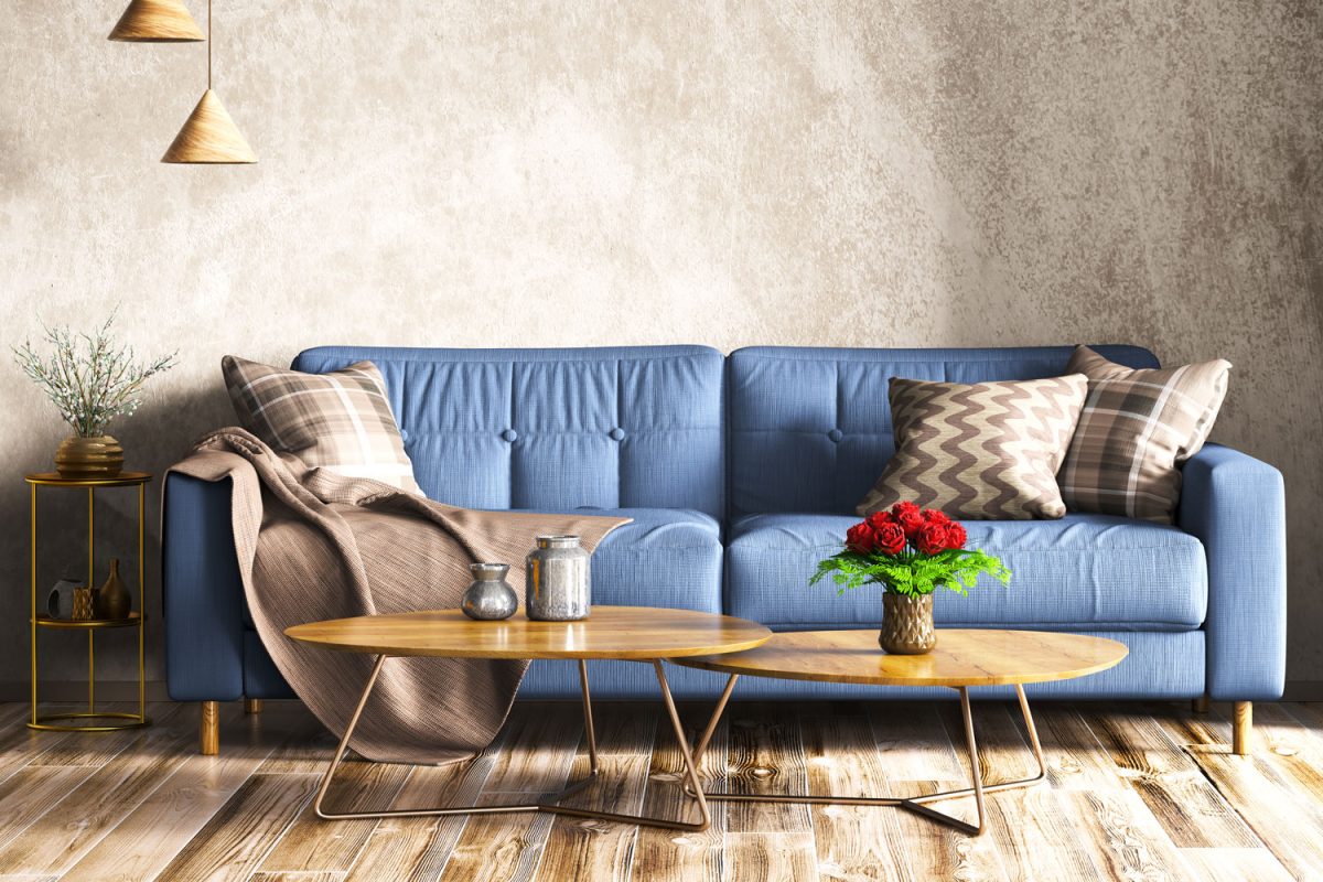 Blue sofa with wooden flooring and brown walls