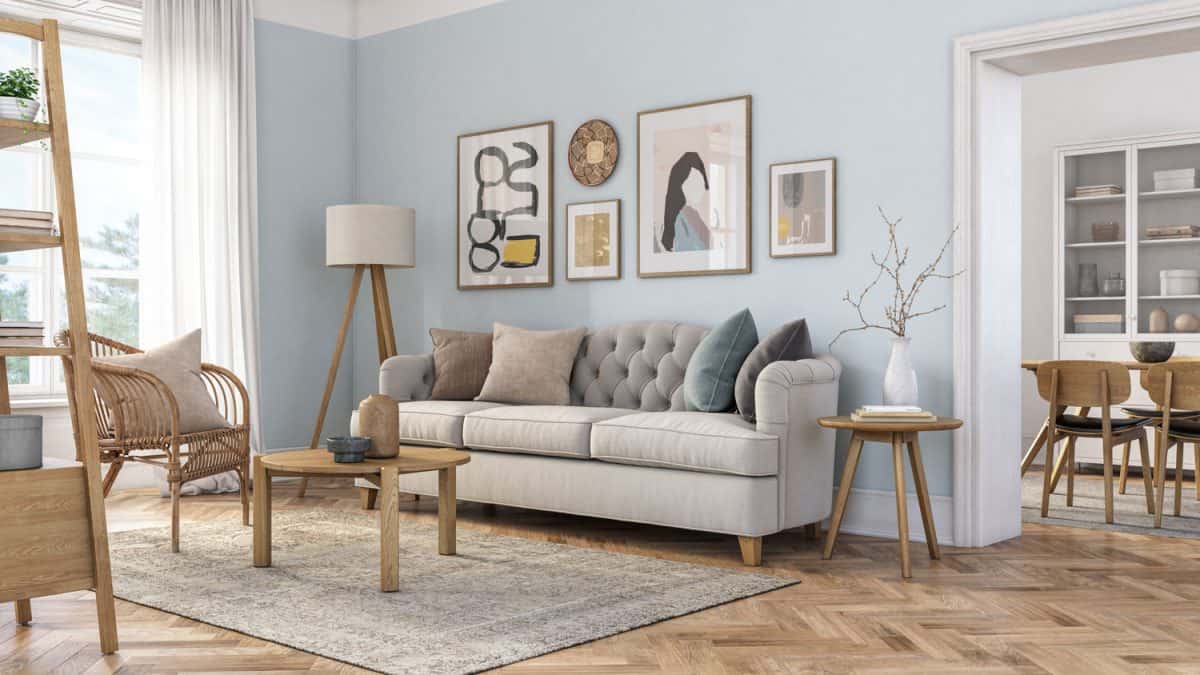 Bohemian living room interior 3d render with beige colored furniture and wooden elements and light blue colored wall