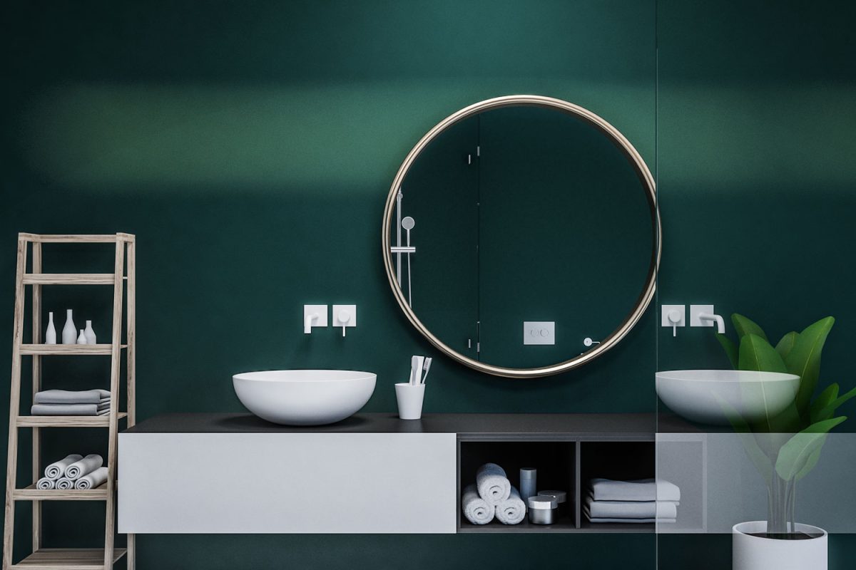 Dark green walled bathroom with a huge circular mirror matching the cabinet in the vanity