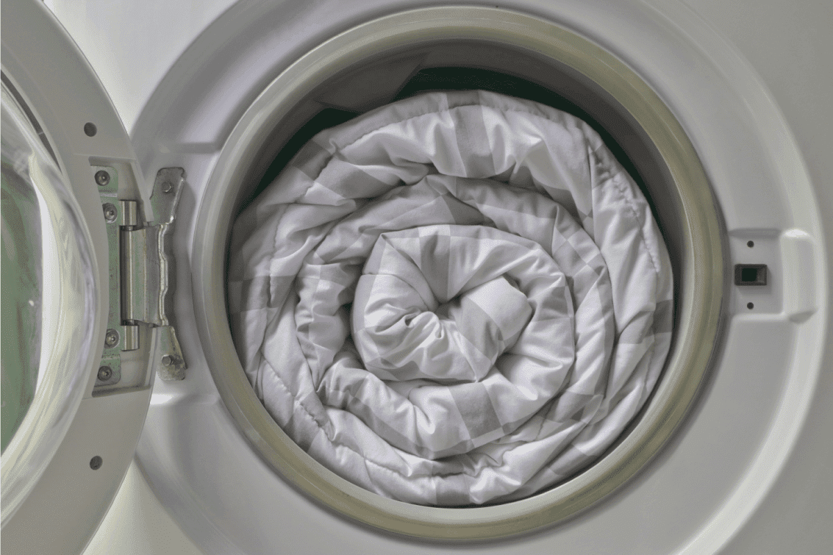 Duvet rolls inside washing machine , Cleaning white blanket.