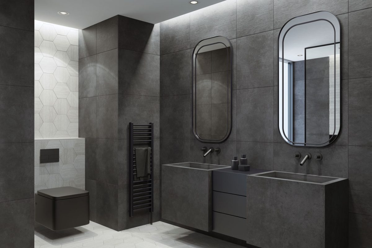 Elegant black themed bathroom with black lavatories and oval shaped mirrors