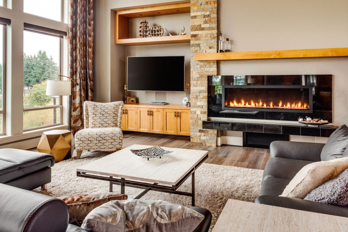 Gorgeous rustic inspired living room with beige painted walls and a fireplace with leather sofa