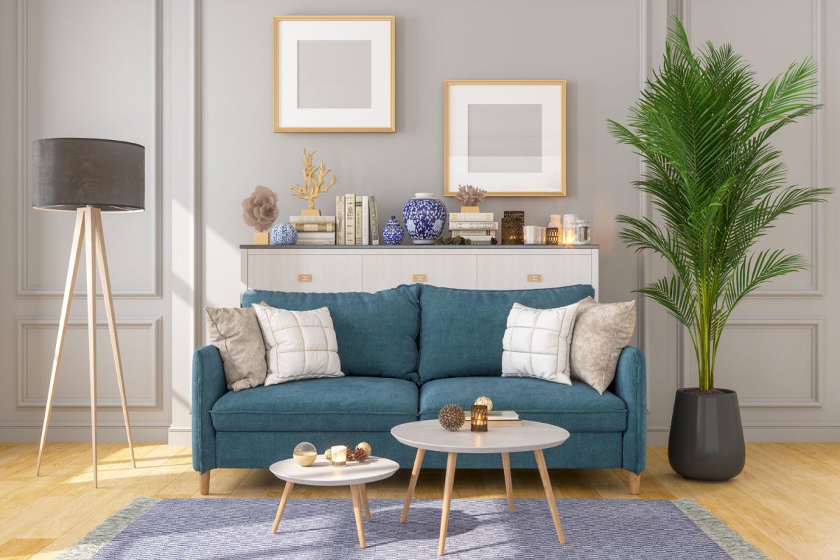 Gorgeous stylish living room with a blue sofa, round coffee tables matched with purple carpet