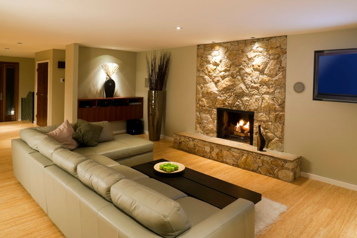 Huge spacious living room with a fireplace decorated with stone cladding