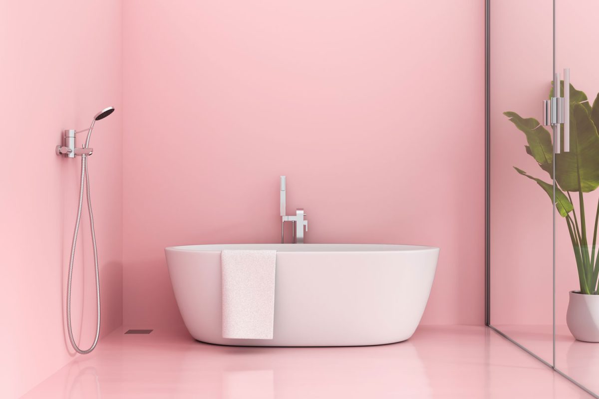 Interior of a pink colored living room with a glass shower area and a white bathtub