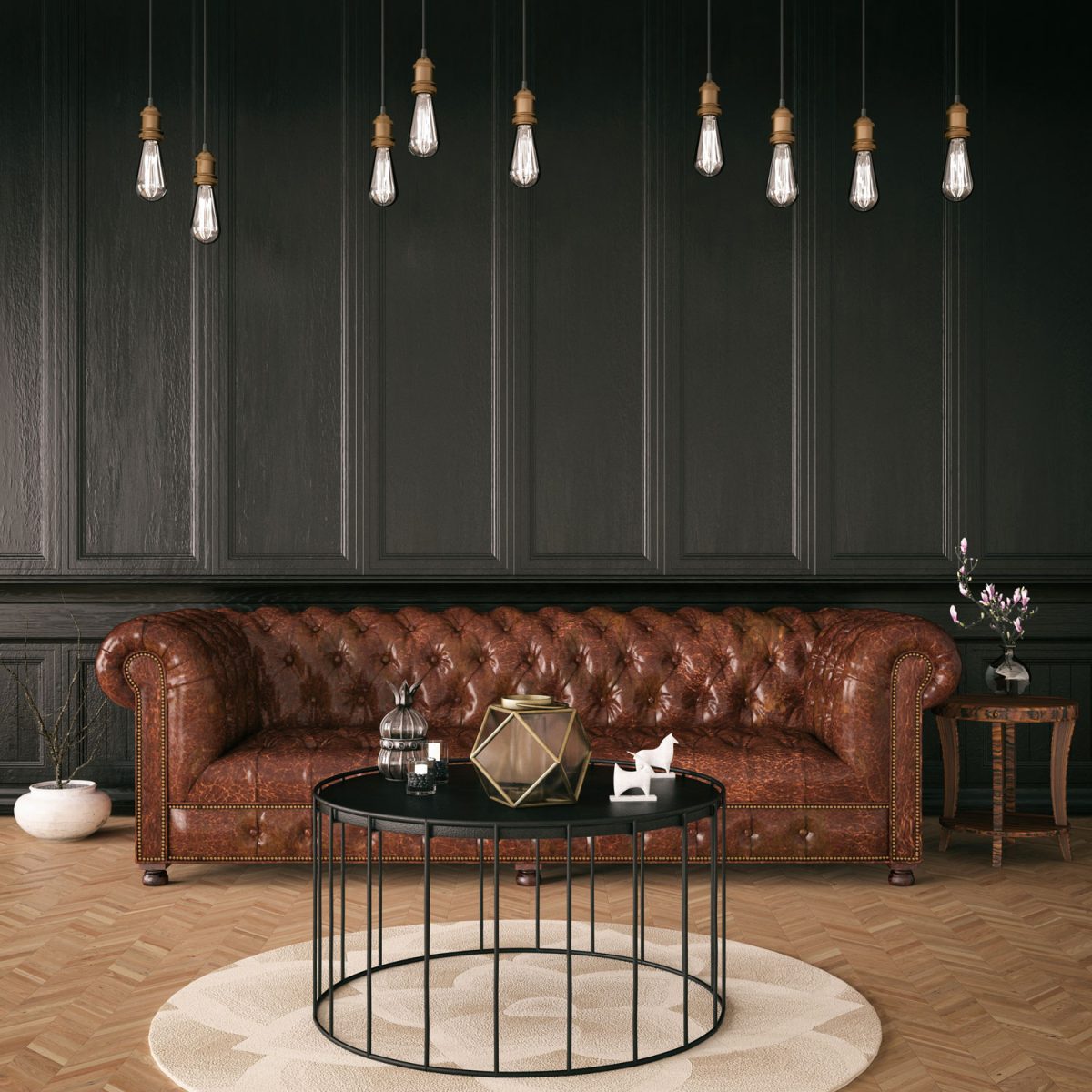 Long brown Chesterfield sofa with dangling lamps and an industrial coffee table up front