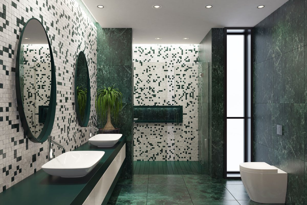 Luxurious modern bathroom with green tiled flooring, black and white tile backsplash and glass shower area