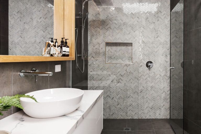 Marble mosaic herringbone tiled shower feature wall in a contemporary ensuite bathroom, 11 Ceramic Bathroom Tile Wall Ideas