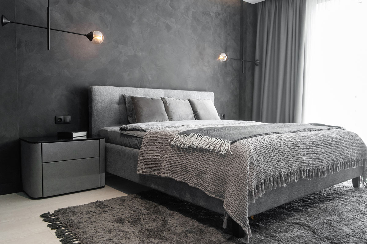 Master bedroom for a lonely stylish man, a bachelor. Modern room with trendy gray interiors, large king-size and stylish lamps, Does Gray Bedding Go With Gray Headboard?