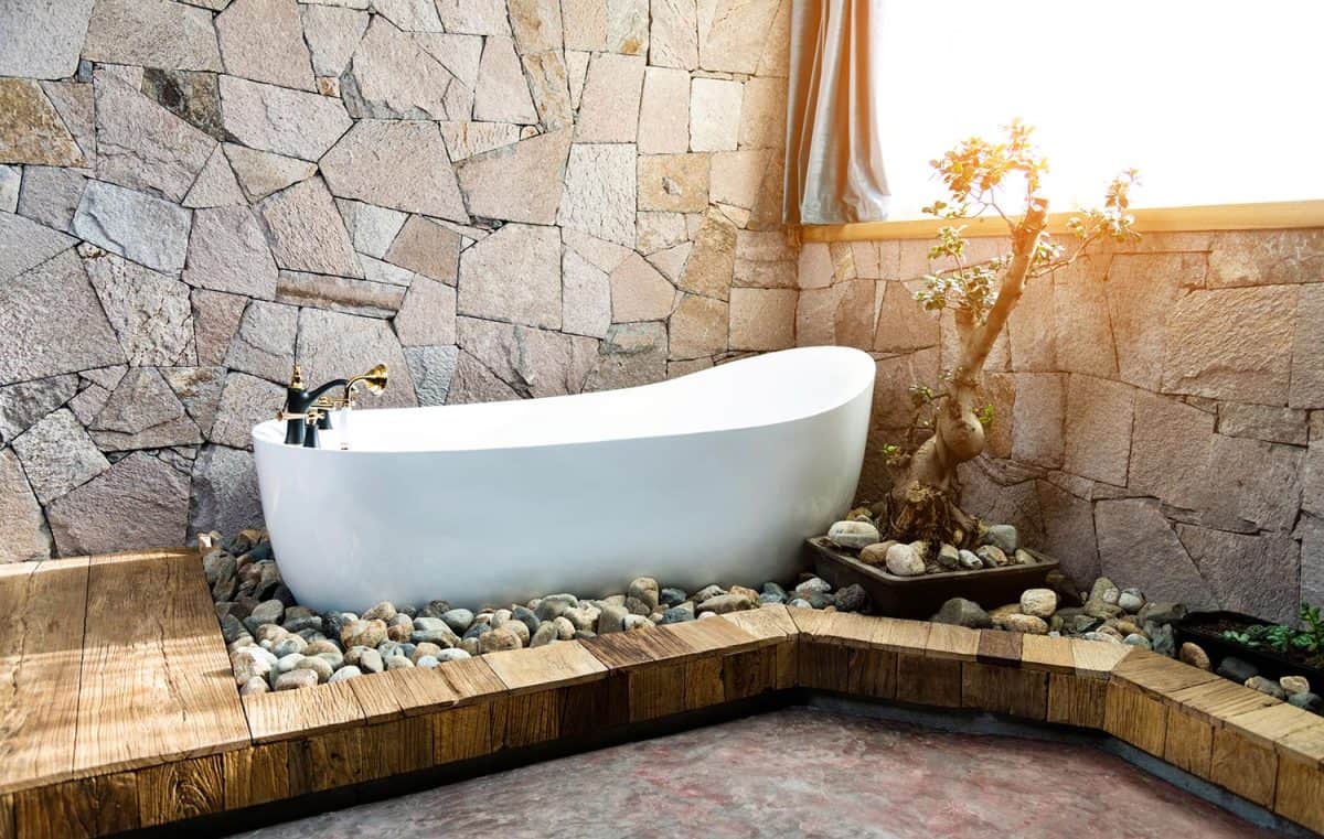 Modern bathroom with stone wall and bathtub