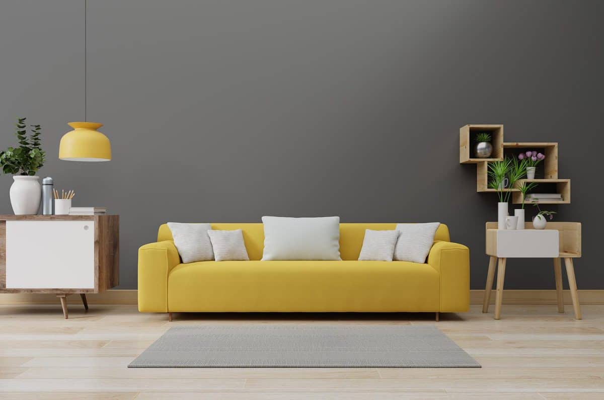 Modern living room interior with yellow illuminating sofa and green plants