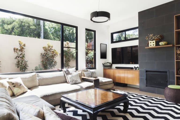 A monochrome living room with wood and grey tiling accents, 11 Black And White Living Room Ideas With An Accent Color