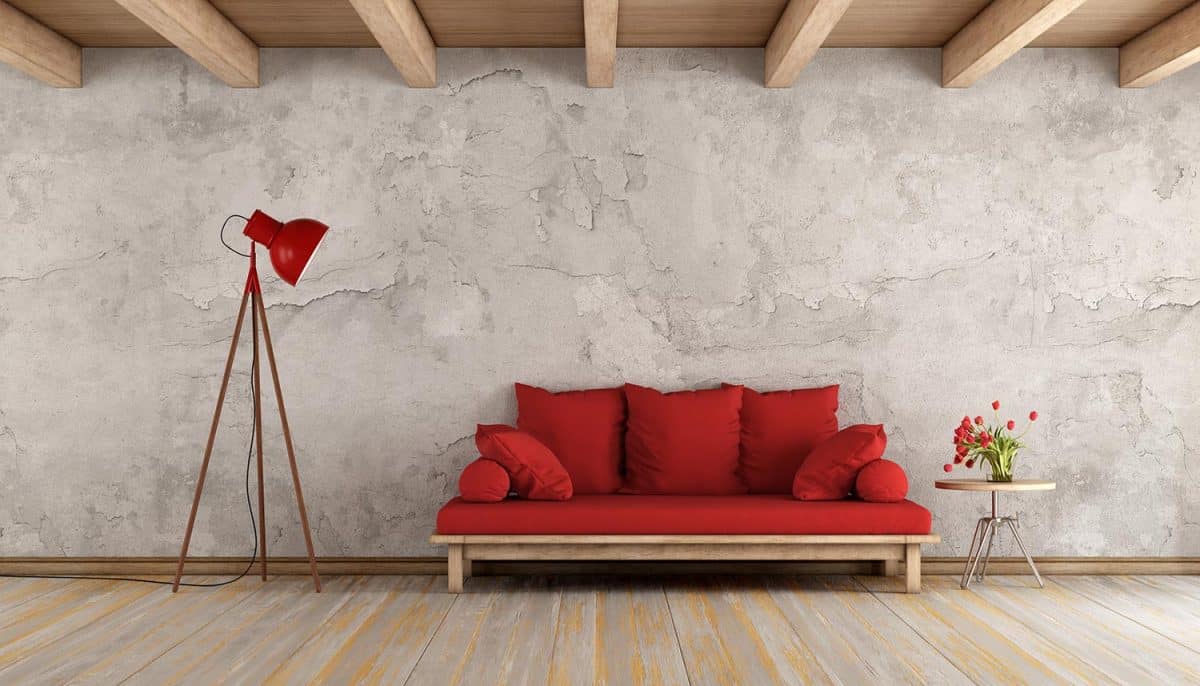 Red sofa in a grunge room,with old wall and wooden ceiling