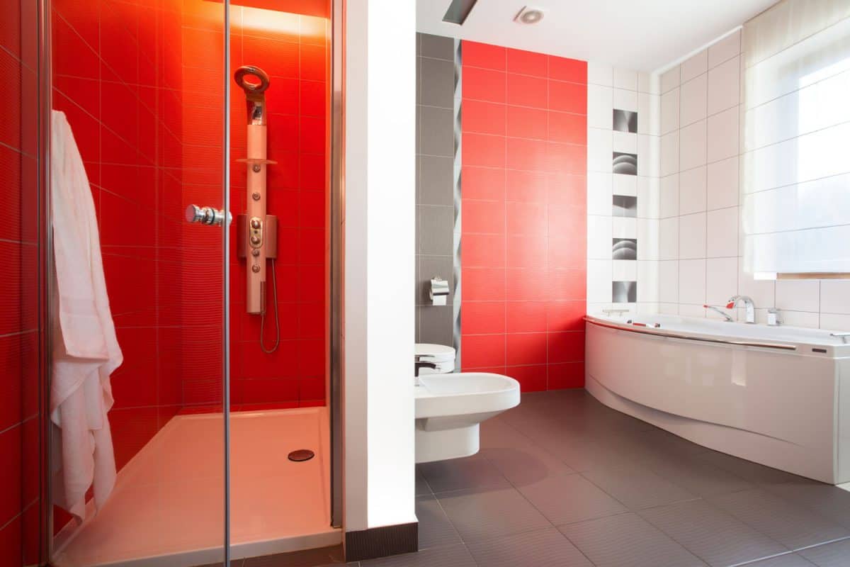Red tiles on the wall in modern toilet