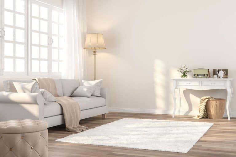 A room that has wooden floors and cream color walls, What Color Couch With Cream Walls?