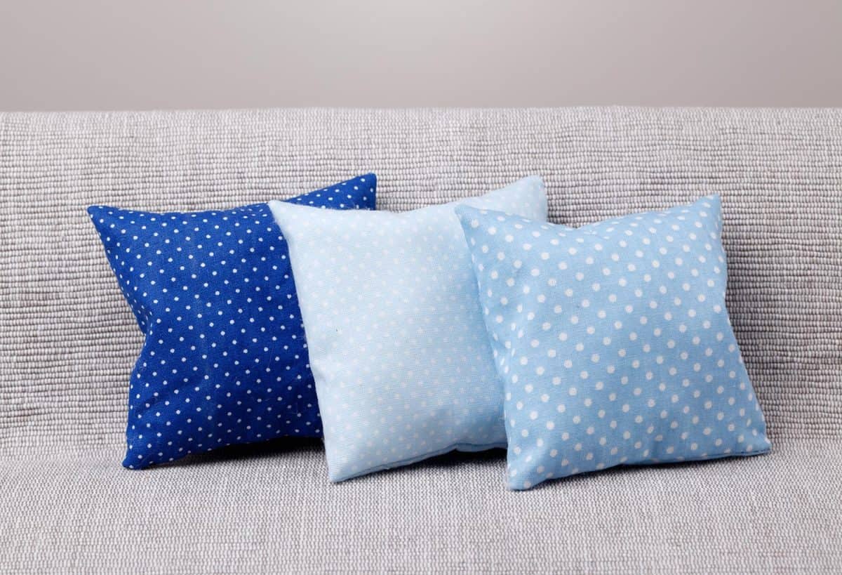 Three blue spotted pillows on the sofa