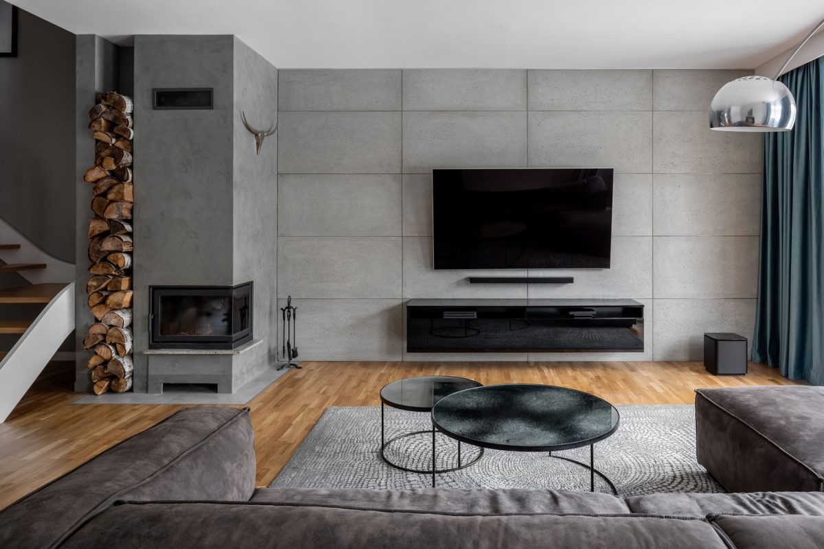 Ultra modern living room with concrete block paneling and wooden hardwood flooring