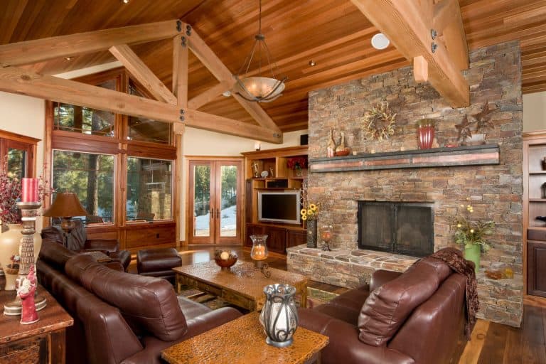 Ultra modern rustic log cabin with a brick fireplace, leather sofas and exposed trusses, 11 Living Room Color Schemes With A Brick Fireplace