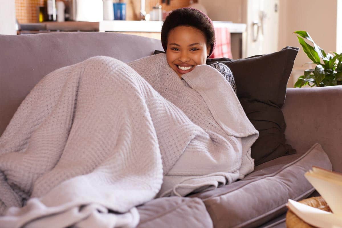 A young woman relaxing at home on the weekend, Do Bamboo Blankets Keep You Warm?