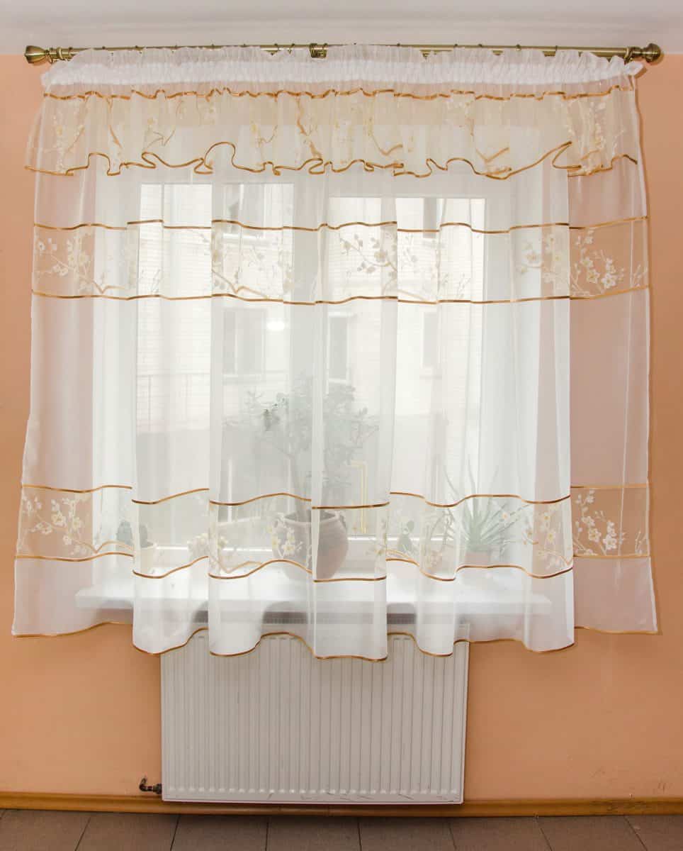 elegant light curtains (tulle) on the window in the kitchen