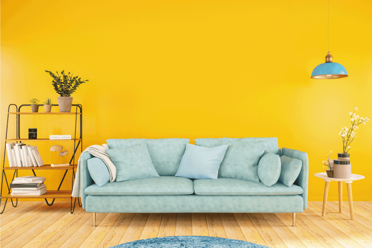 mint green couch, sofa table, side organizer inside a yellow living room
