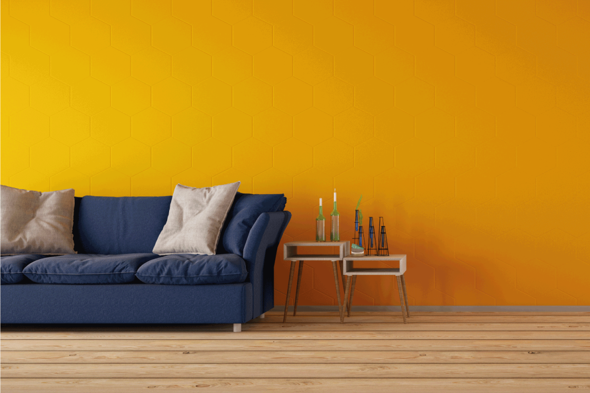 navy blue sofa inside a yellow living room