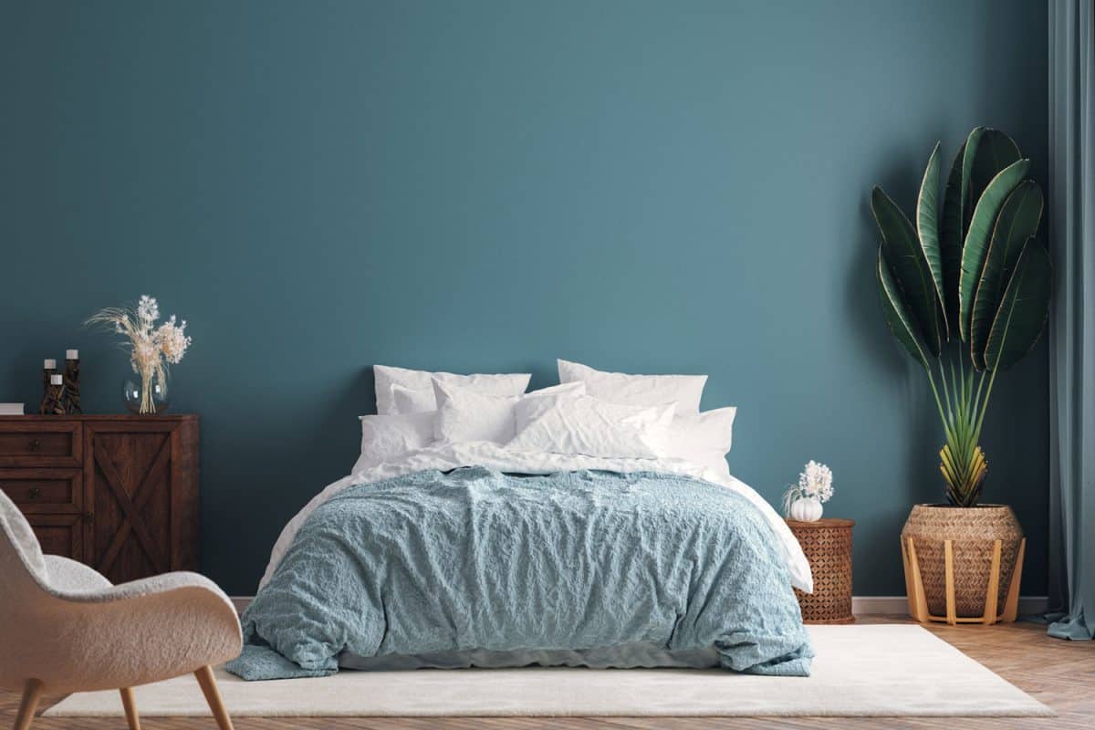 A blue inspired bedroom with blue and white beddings and wooden flooring