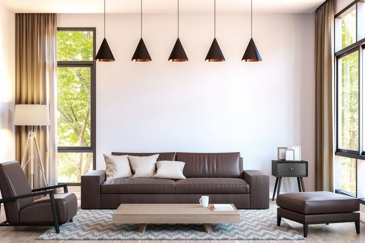 A brown and white themed living area with triangular shaped dangling lamps