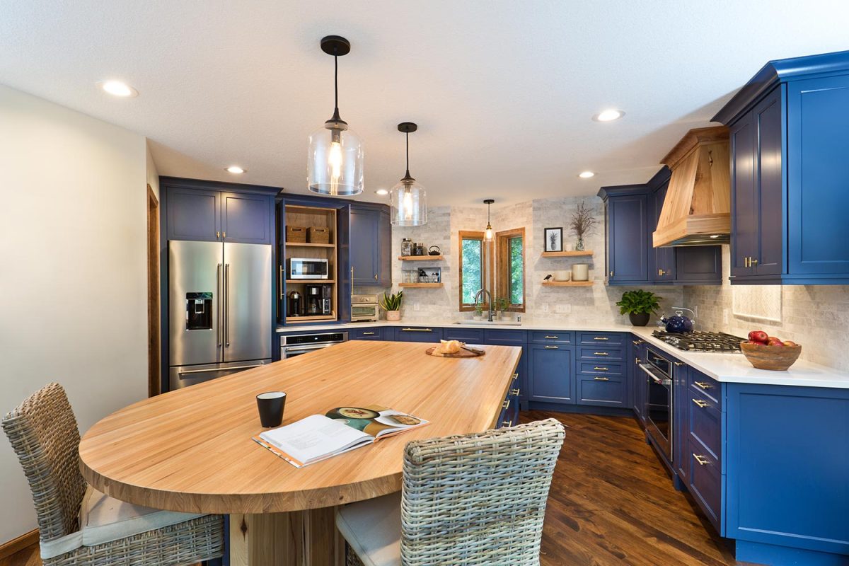 A contemporary kitchen renovation remodeling featuring a center island, hardwood floor and quartz counter