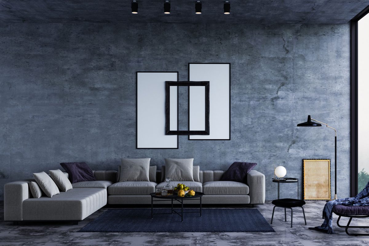 A dark blue designed living area with a gray sectional sofa and a wall decorated with white canvas