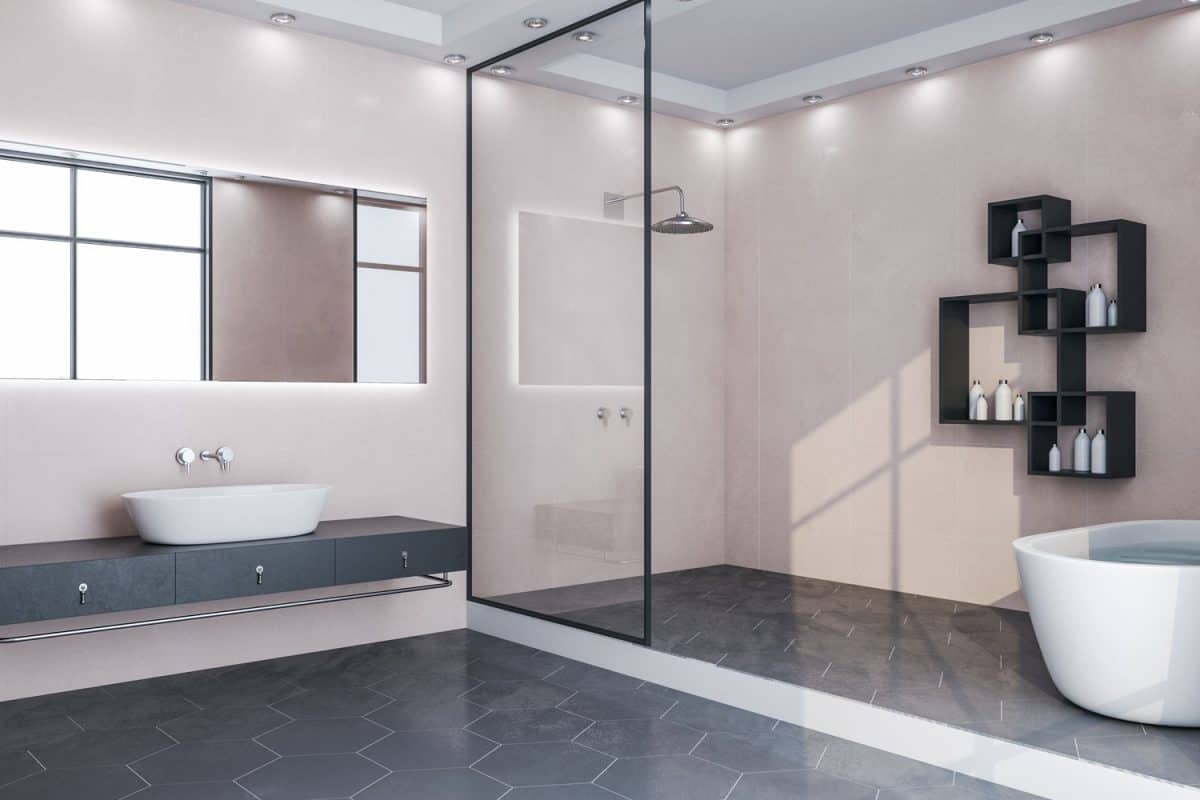 A glass walled shower room with pin lights and a vanity with a three black cabinets