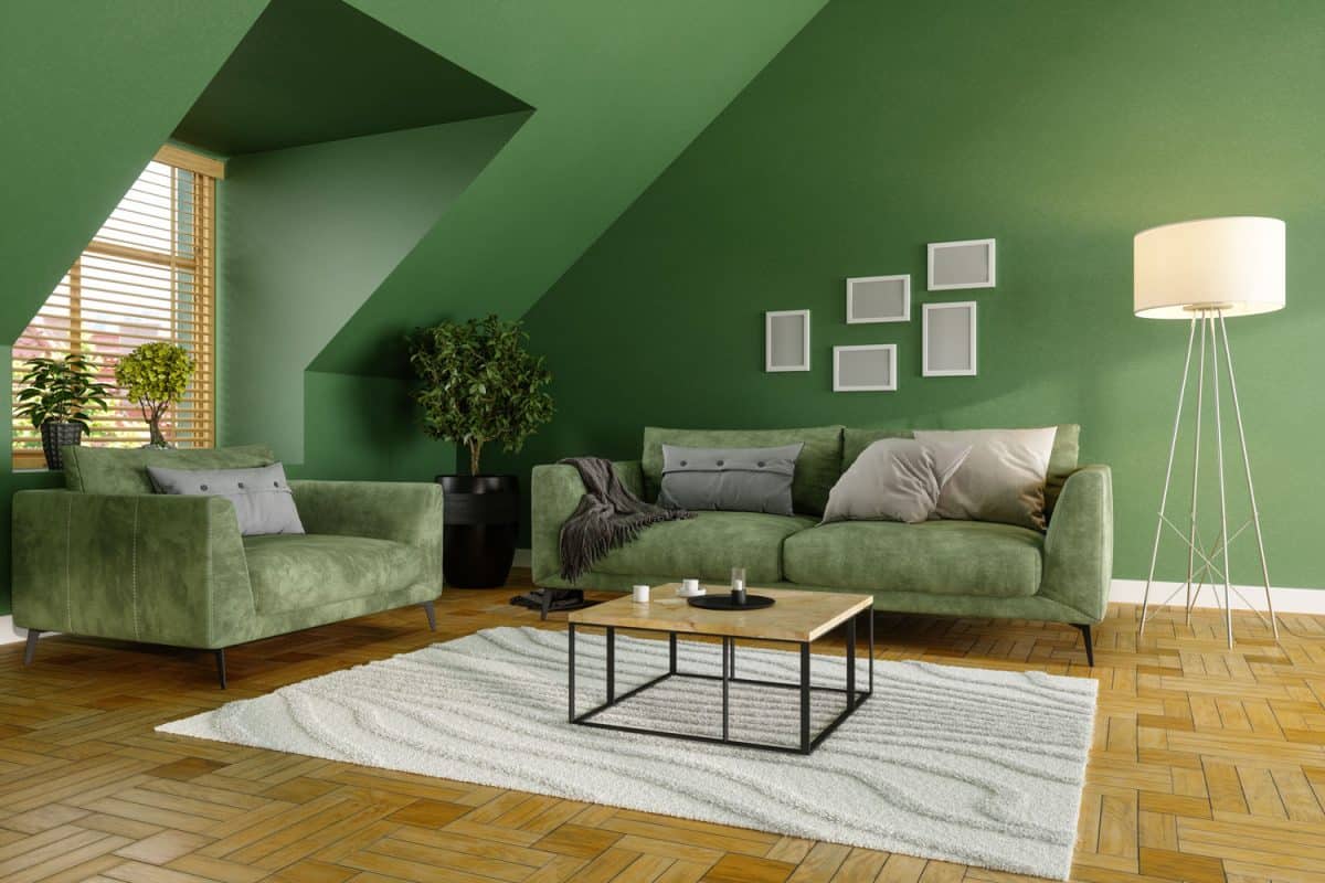 A green mansard bedroom with green furniture's matched with bonsai plants and white furnitures