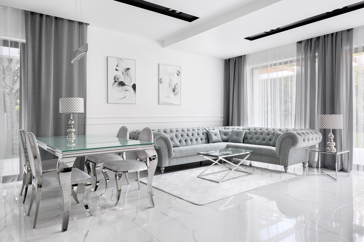 Charming and luxury living room in gray and white with glass table and glamour style corner sofa