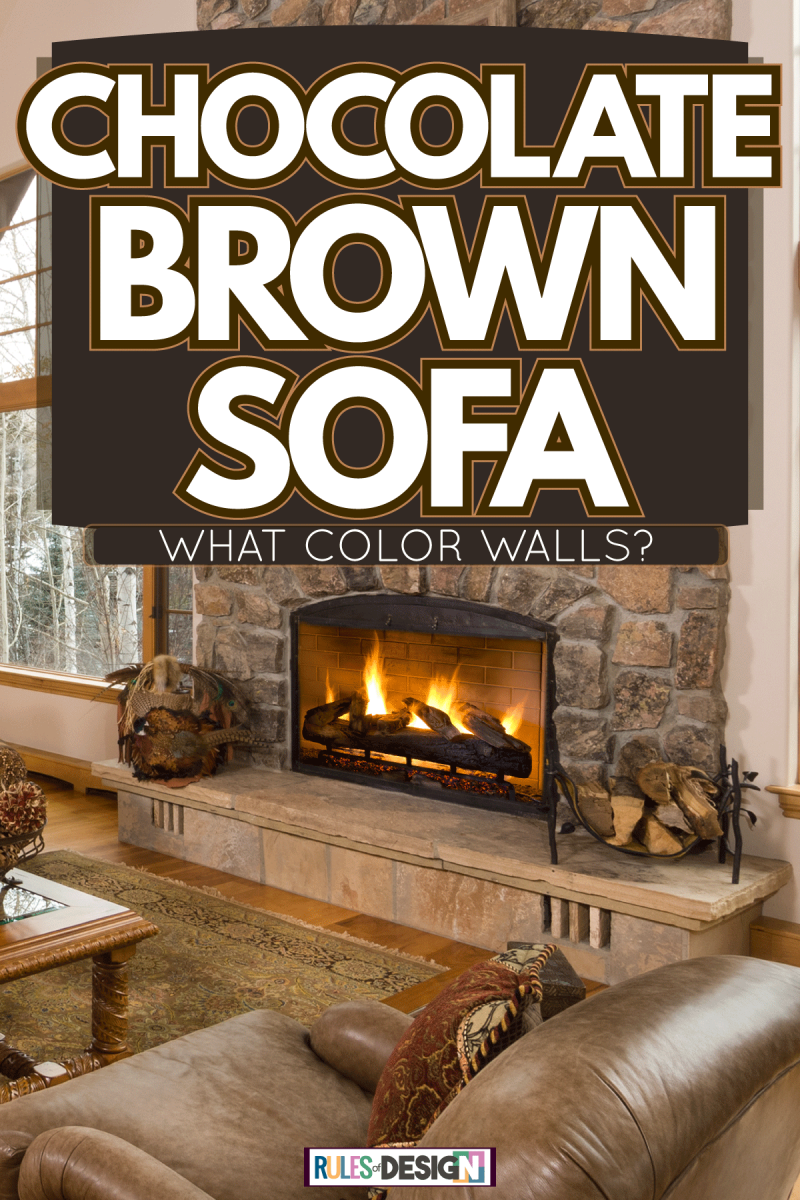 Huge rustic inspired barnhouse matched with wooden flooring, beige walls and brown leather sofas with a huge fireplace decorated with stones, Chocolate Brown Sofa - What Color Walls?