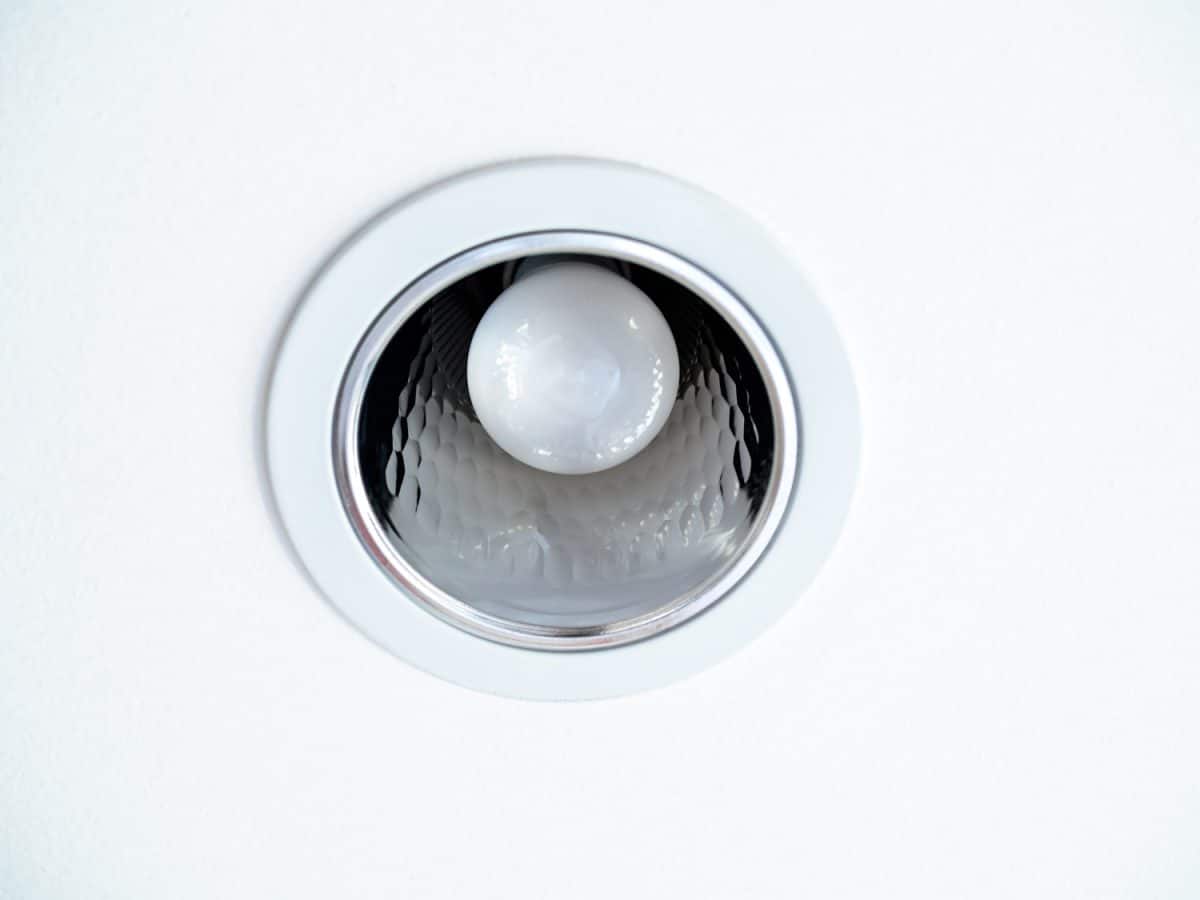 Close-up LED ceiling light. Downlight with light bulb on white ceiling background.
